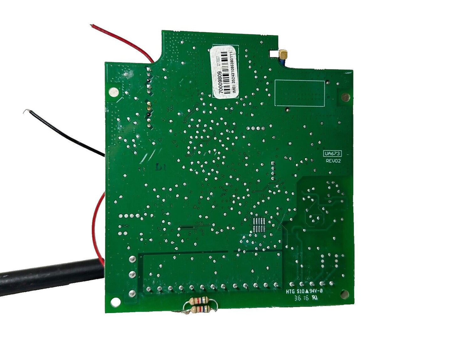 Green fire alarm control board with wiring, IMEI label, and circuit components for fire safety systems