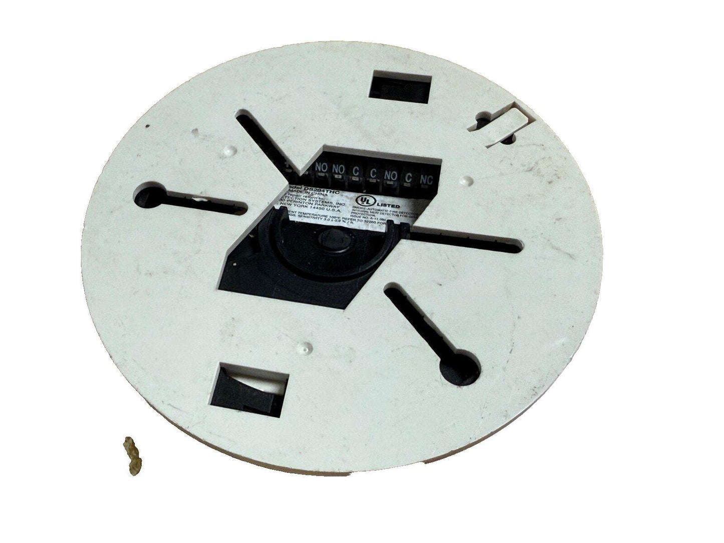 White circular fire alarm detector base with terminal connections and UL listed label