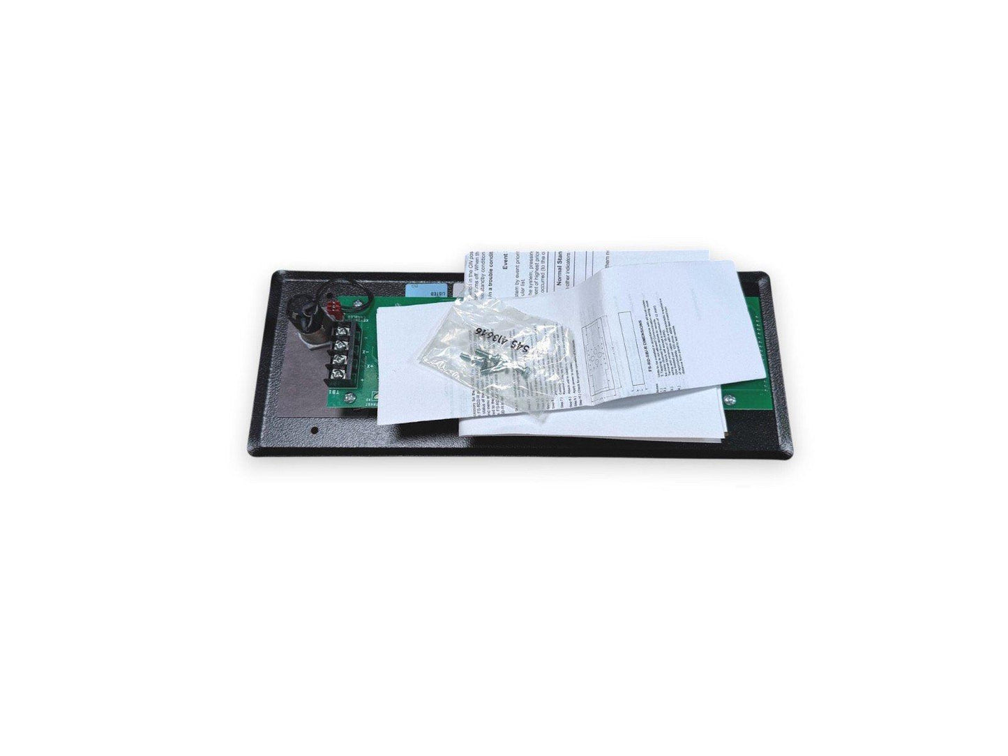 Fire alarm control module with circuit board, manual, and mounting hardware on black base