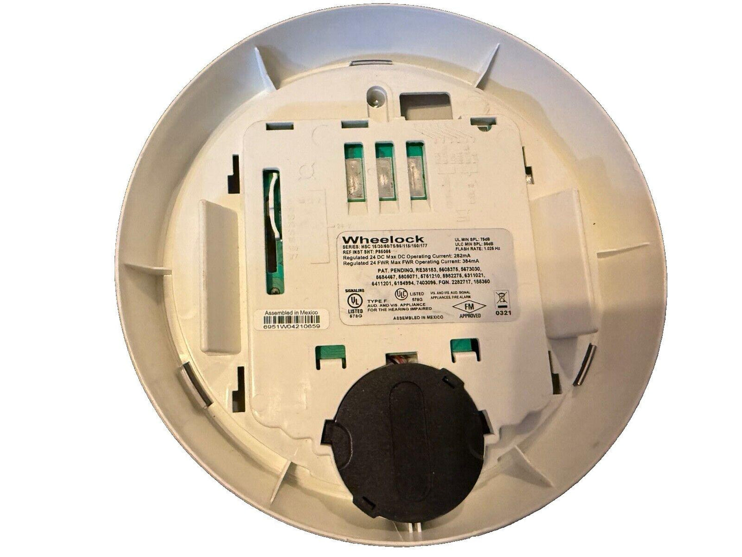 Wheelock fire alarm device back view with wiring terminals and certification labels