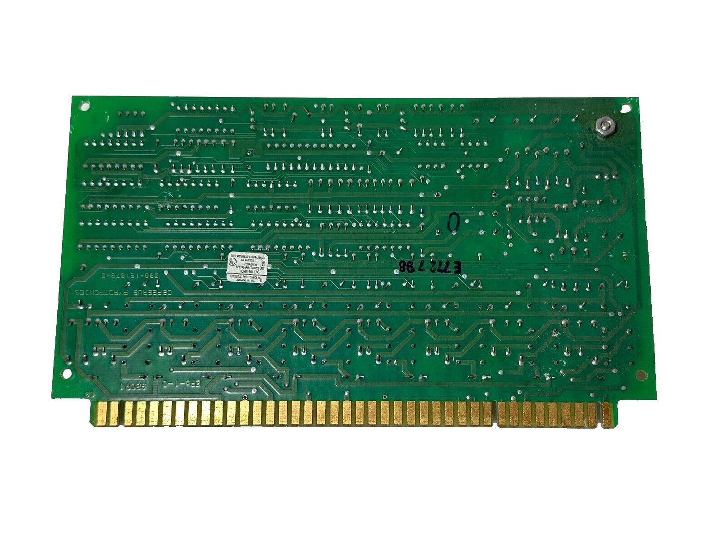 Green fire alarm control panel circuit board with gold connectors and UL certification label
