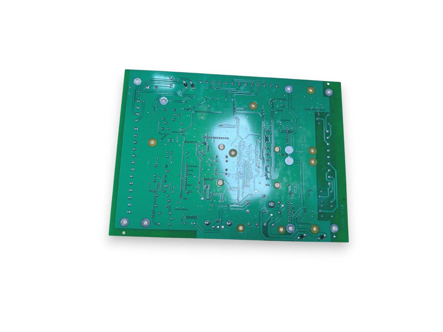 Green fire alarm control panel circuit board with solder points and traces