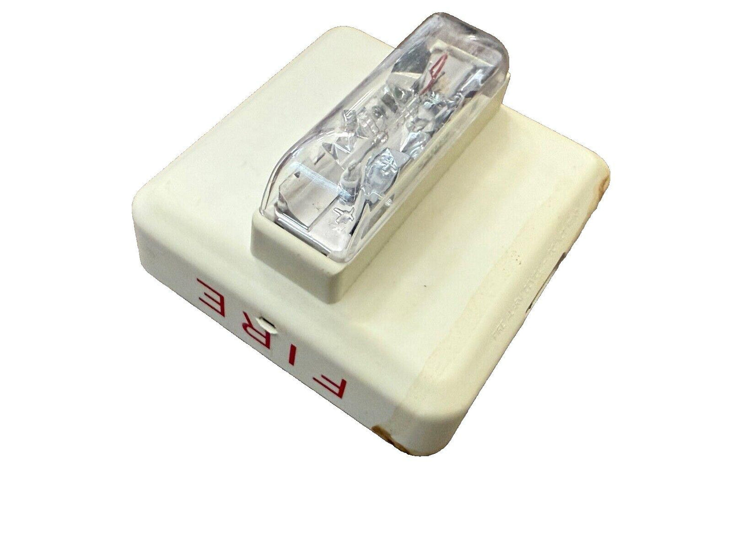 White fire alarm strobe light with red FIRE label, used fire safety equipment