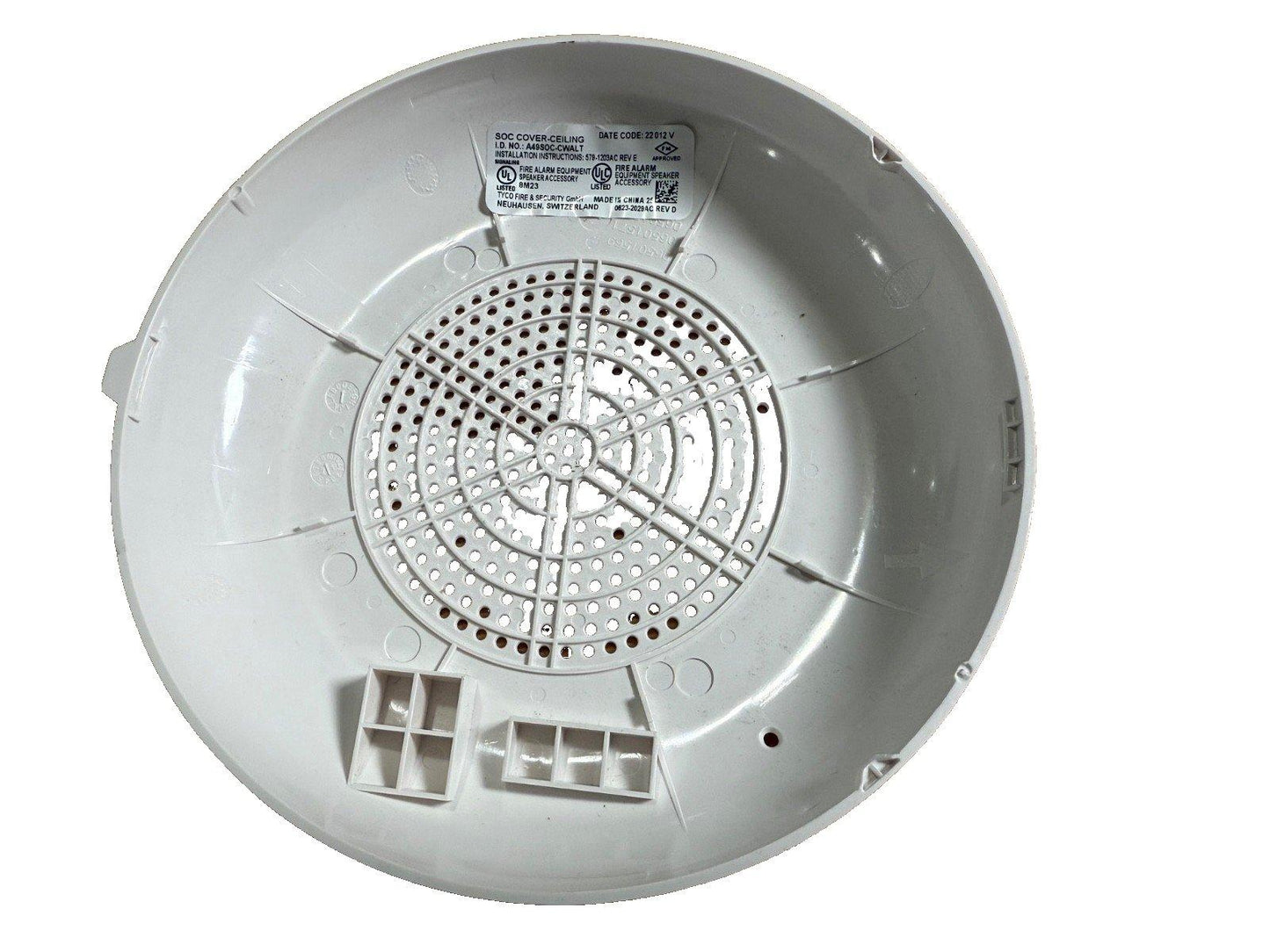White fire alarm speaker cover with UL listed label, perforated grille, and mounting tabs for ceiling installation