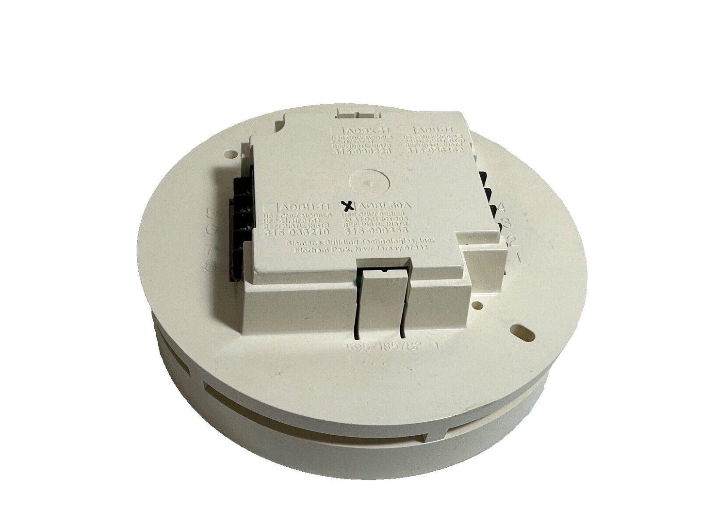 White fire alarm detector base with wiring terminals and model labels, compatible with fire safety systems