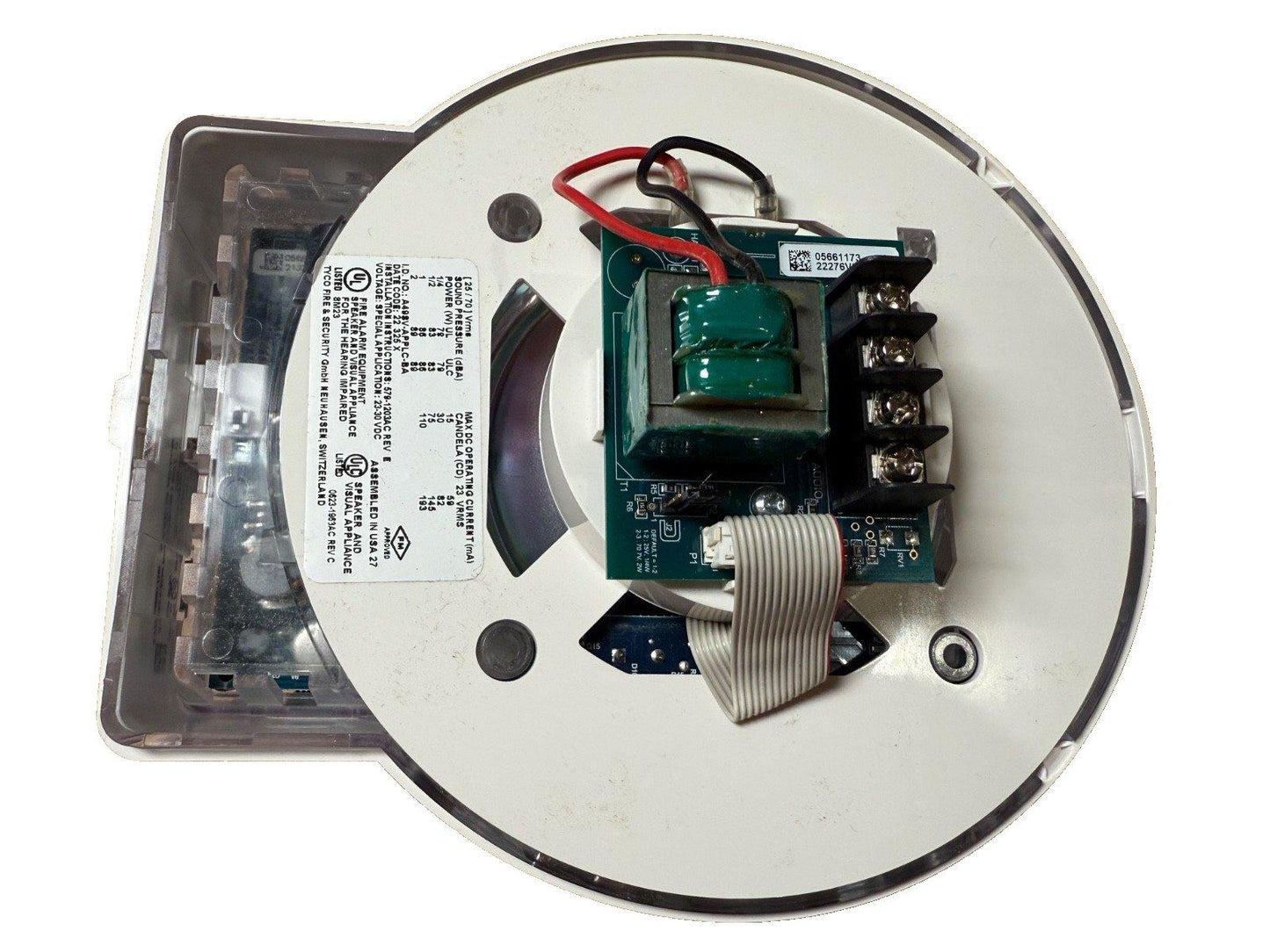 Fire alarm speaker strobe with exposed circuit board, wiring, and UL-listed label for commercial use