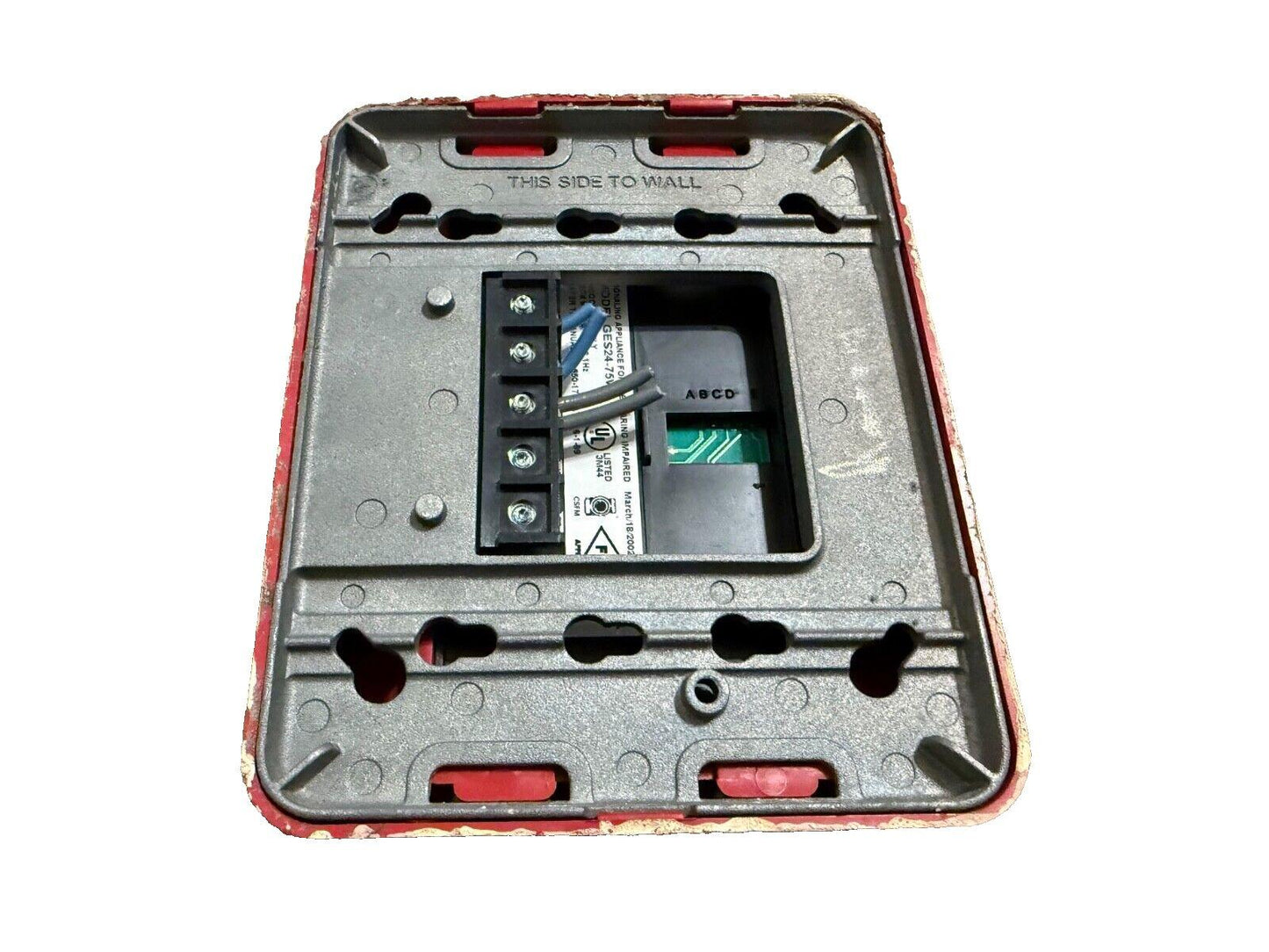 Used fire alarm control module with wiring terminals and circuit board, labeled 'THIS SIDE TO WALL'