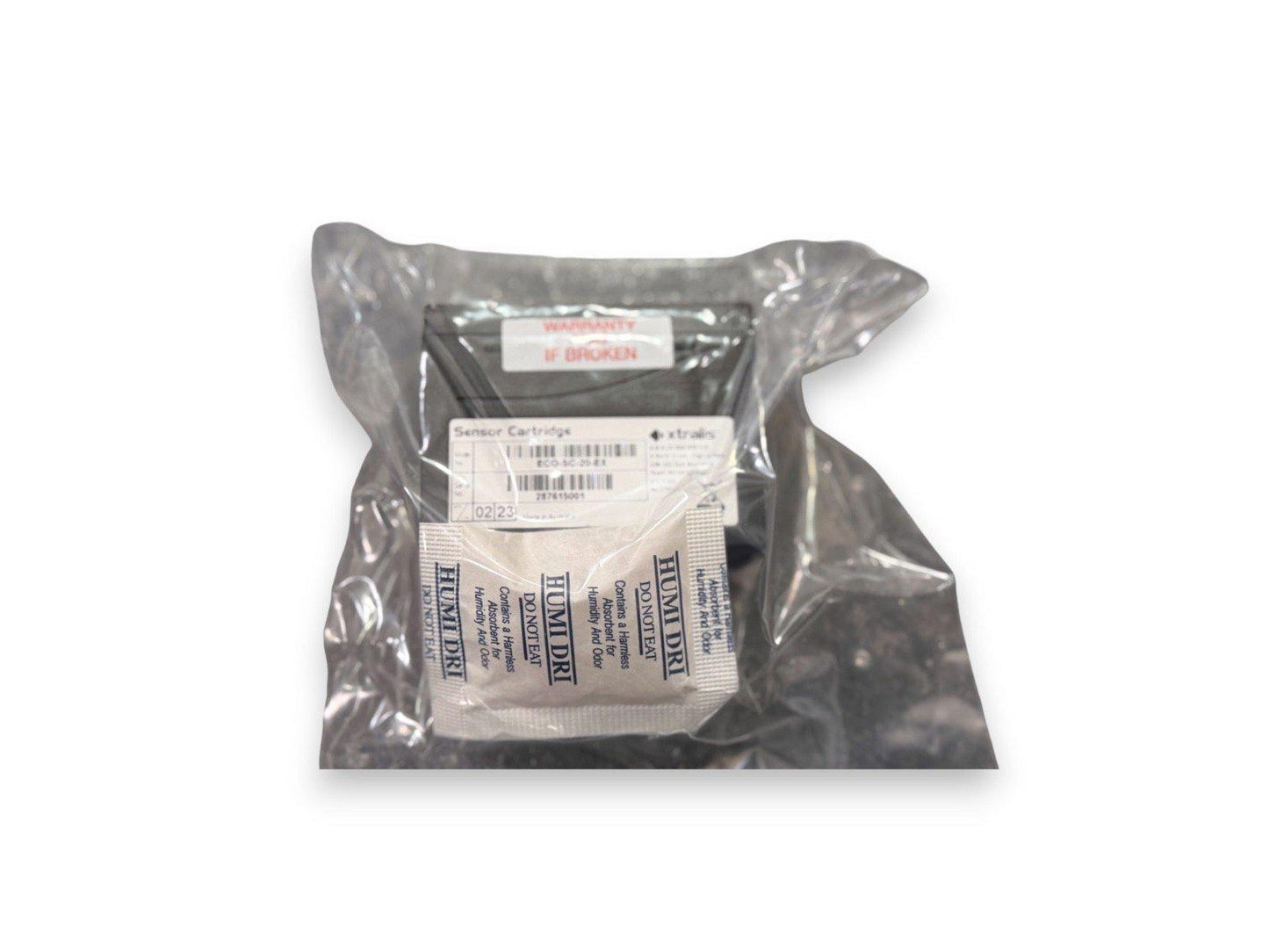 Sealed fire alarm sensor cartridge with humidity absorber packet, labeled for safety and warranty.