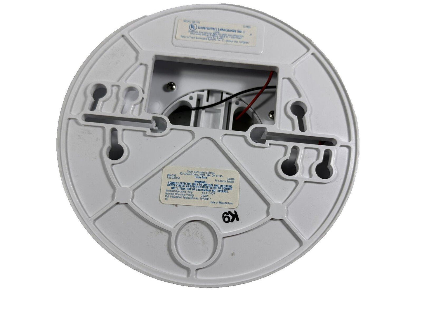 White fire alarm relay base with wiring terminals and UL label, compatible with Thorn systems