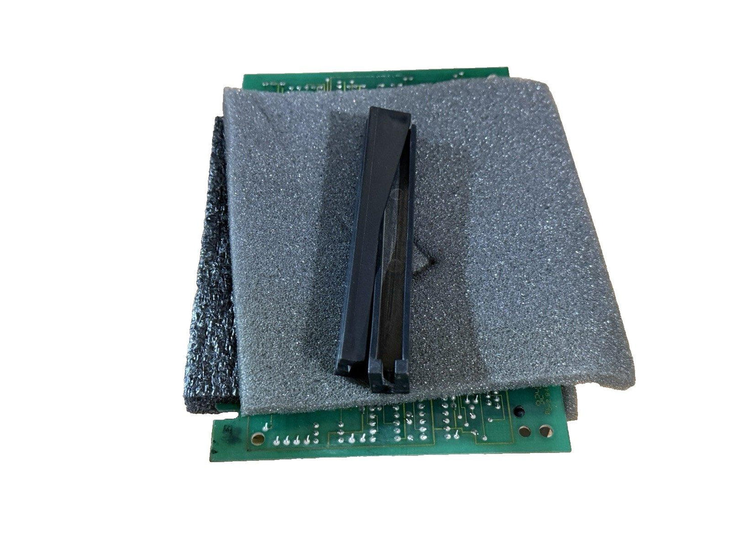 Fire alarm control panel circuit board with protective foam and black plastic clips