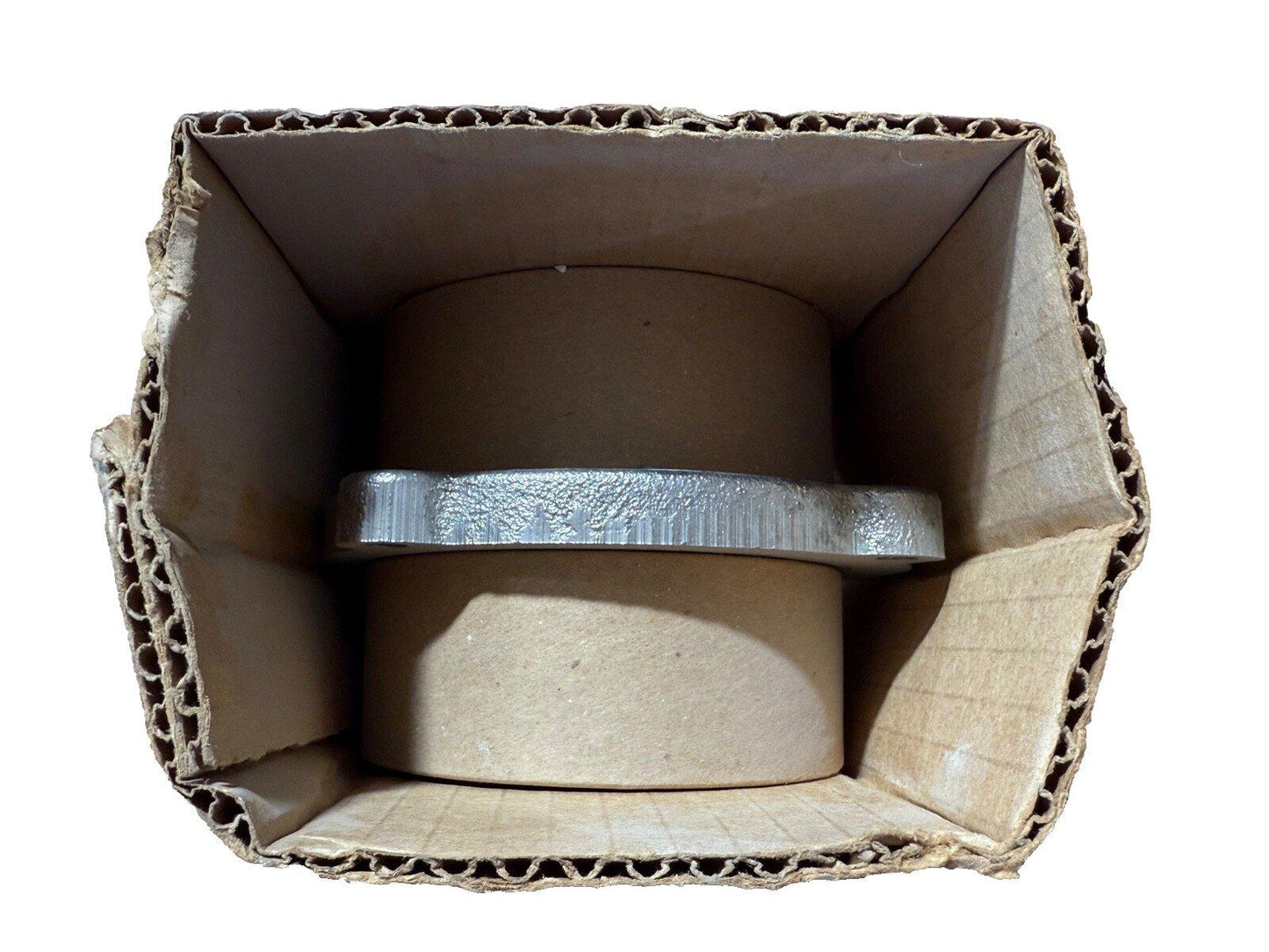 Fire alarm bell housed in cardboard packaging, ready for installation or shipping.
