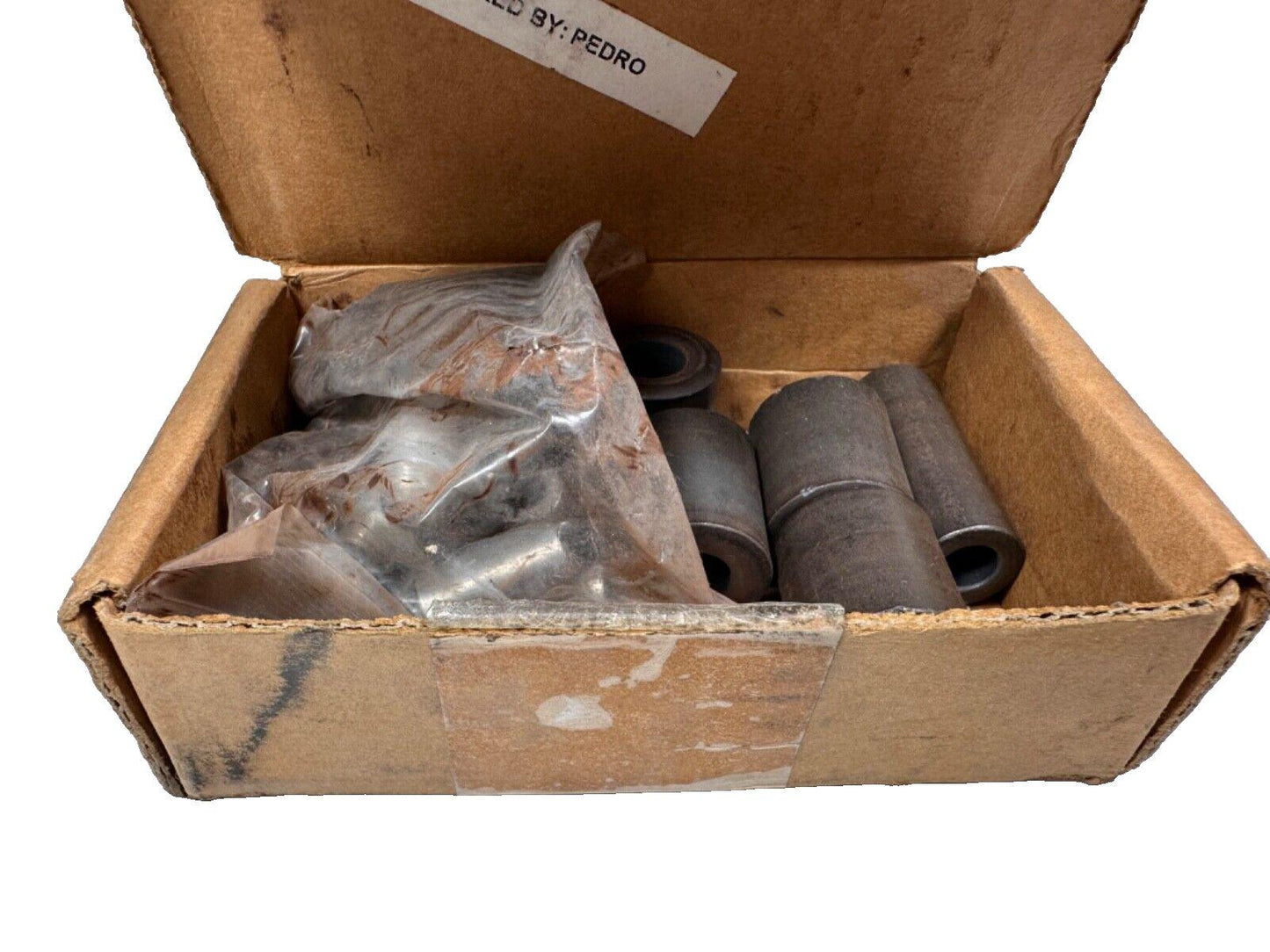 Used fire alarm system parts in cardboard box, including metal fittings and packaged components