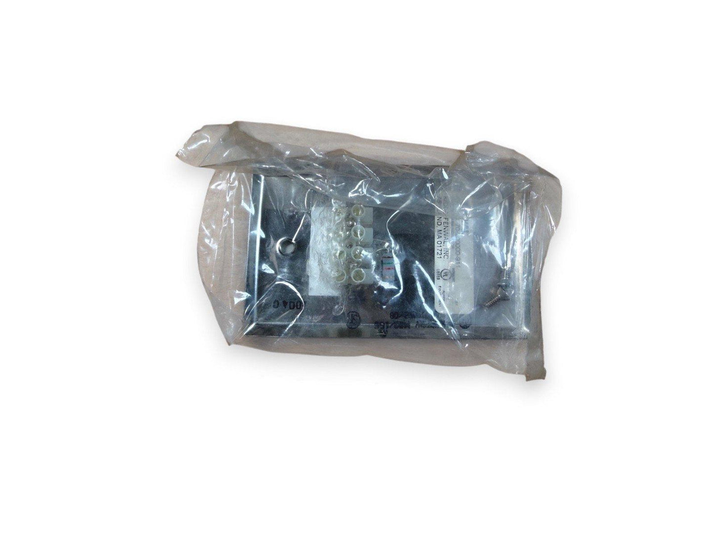 Fire alarm control panel module in plastic packaging, ready for installation
