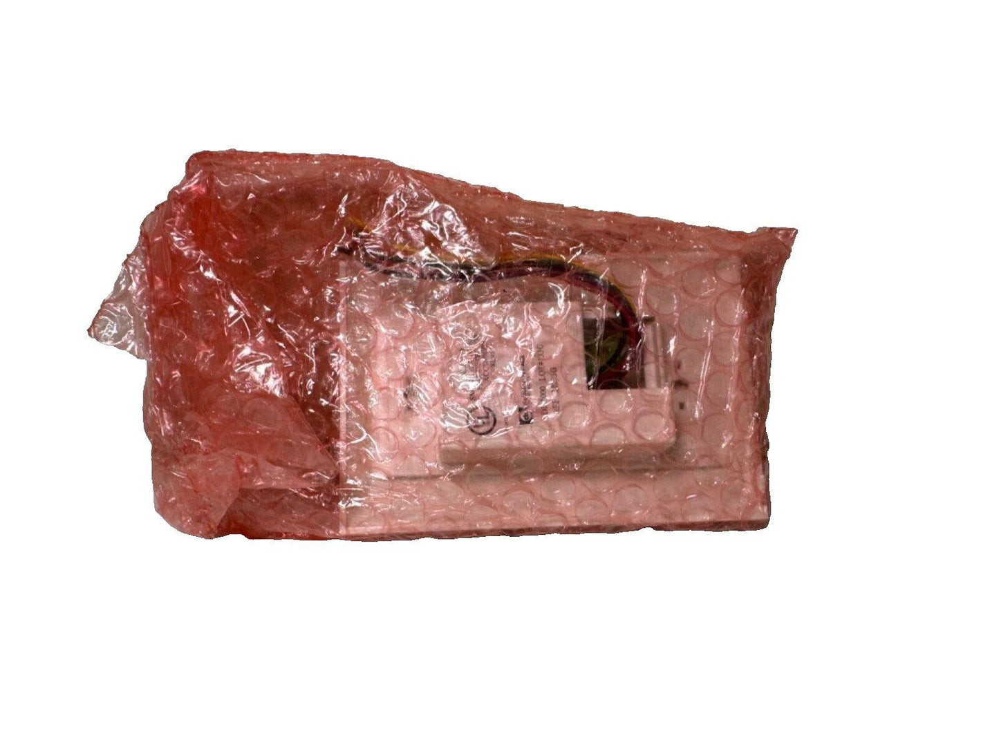 Fire alarm control module wrapped in red bubble wrap, ready for shipping