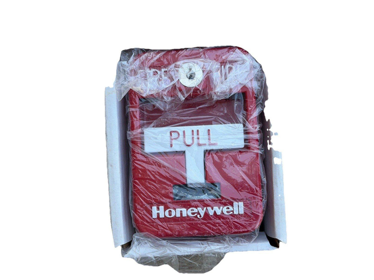 Honeywell red fire alarm pull station in packaging, new fire safety equipment