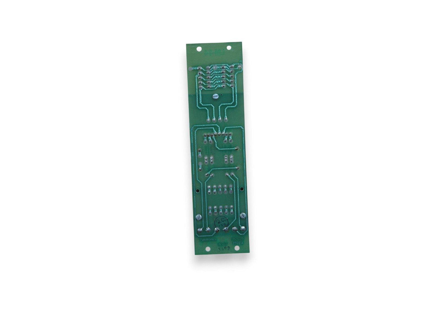 Green fire alarm control panel circuit board with soldered components and mounting holes
