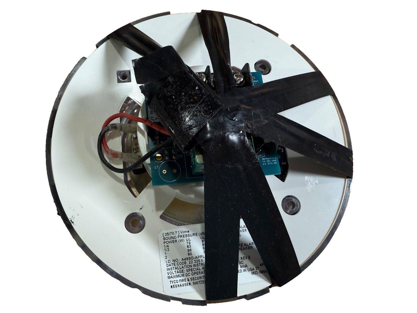 Fire alarm speaker with internal wiring and circuit board, labeled for Tyco Fire & Security