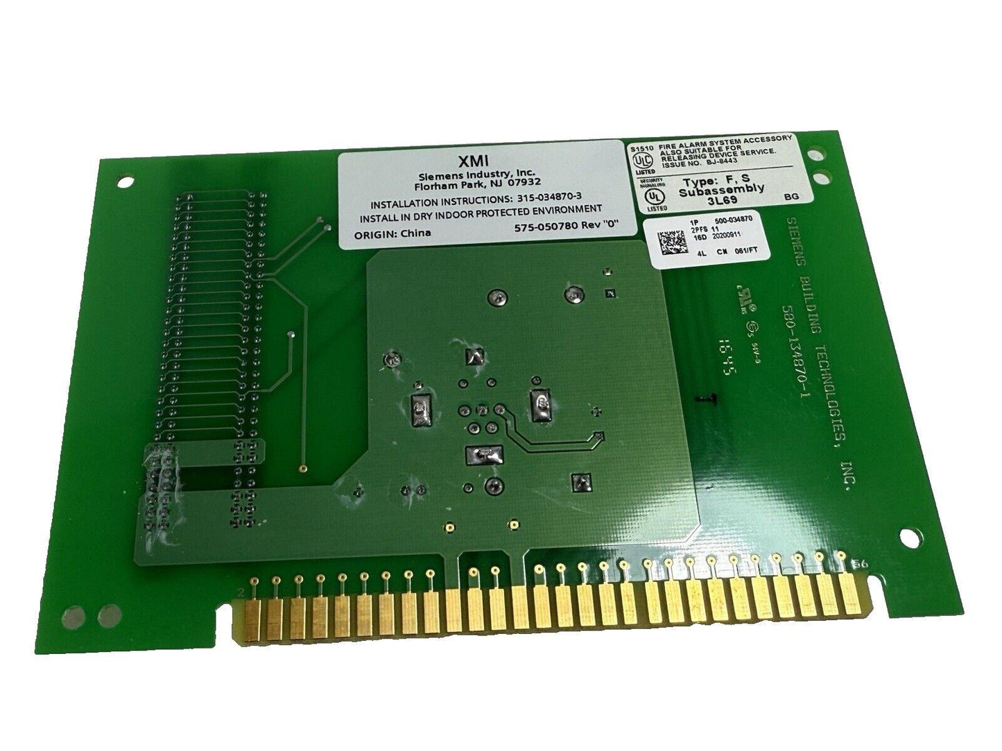 Siemens XMI fire alarm system circuit board with gold connectors and UL listing labels