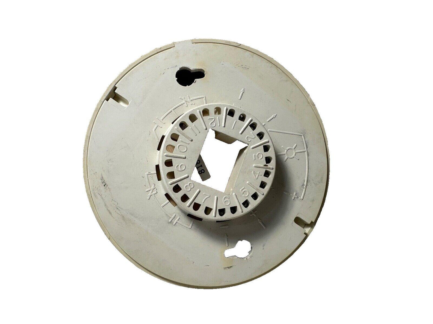 White fire alarm base with numbered terminals and mounting slots for security systems