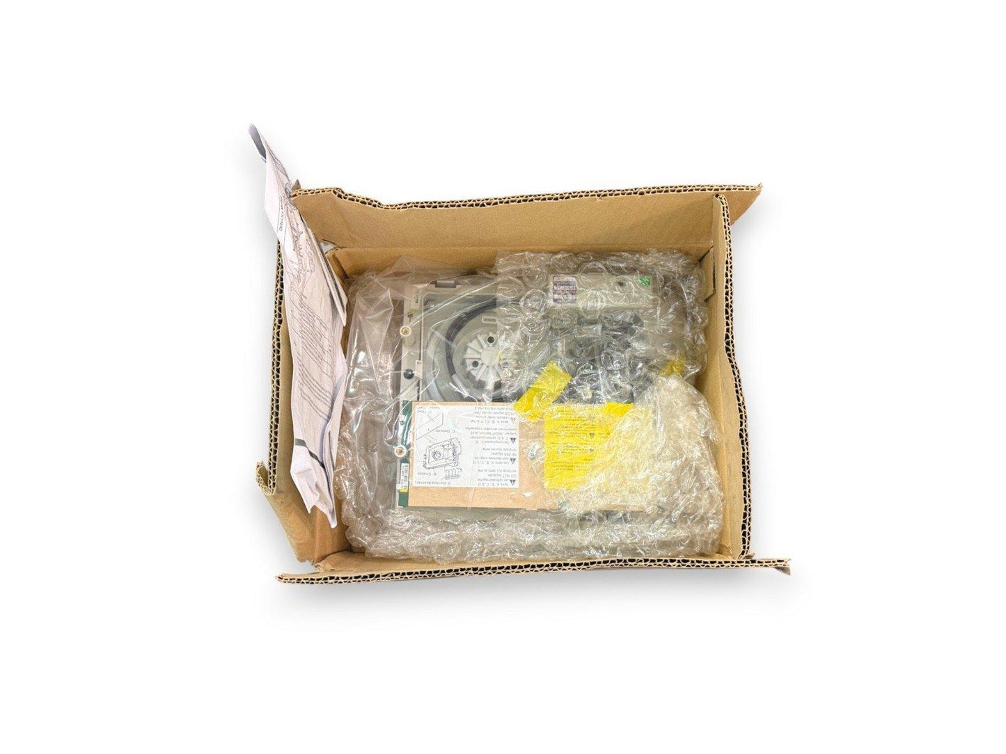 Fire alarm control panel in box with bubble wrap and manual, ready for installation