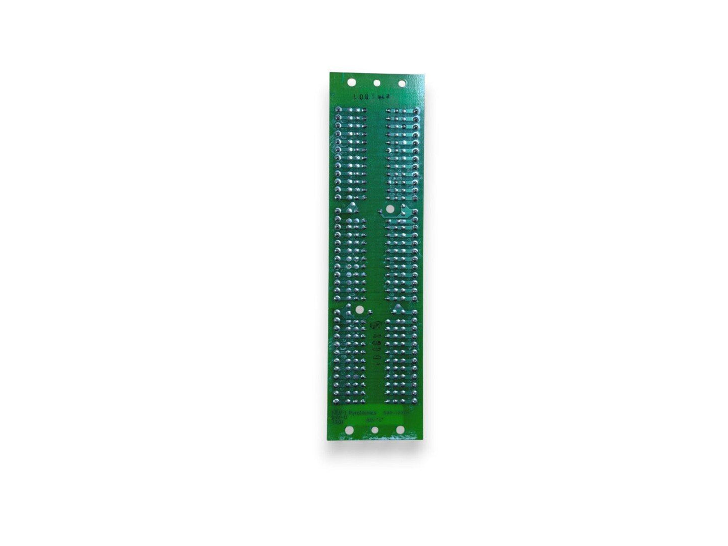 Green fire alarm control panel circuit board with solder points and mounting holes