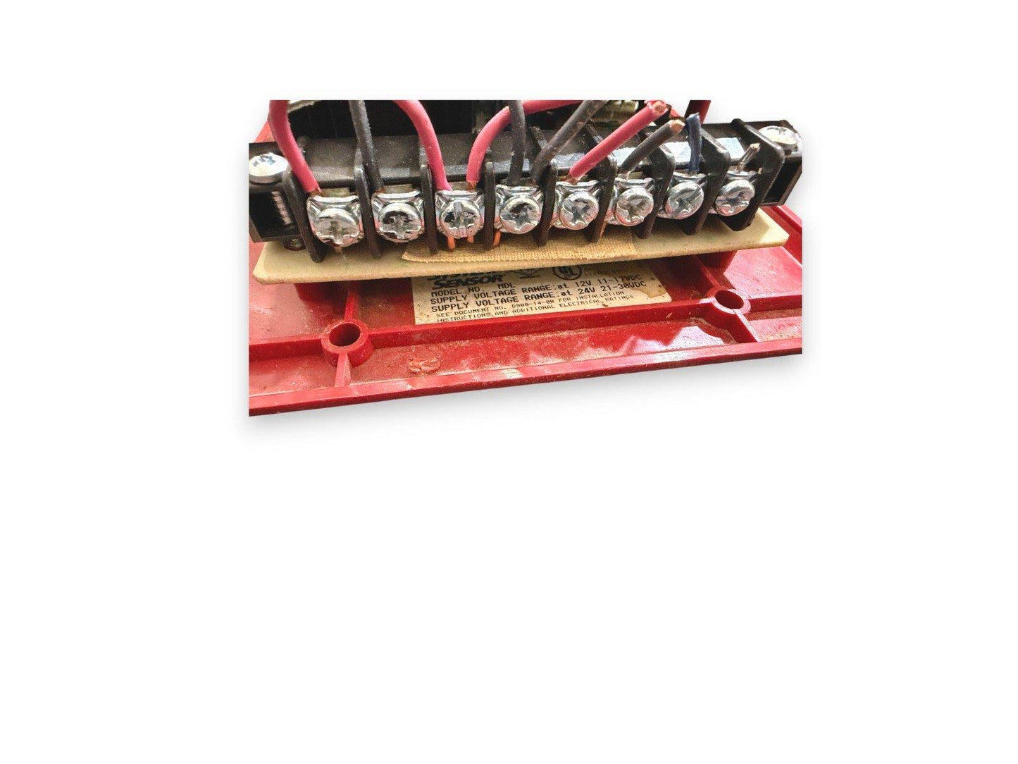 Fire alarm control panel terminal block with red and black wires connected, model MDL, 12V/24V DC