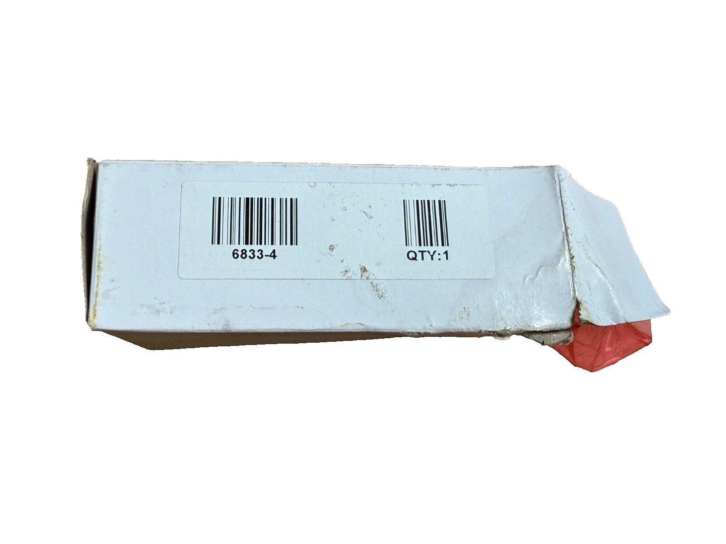 Used fire alarm equipment box with barcode 6833-4, quantity 1, showing wear and red packaging