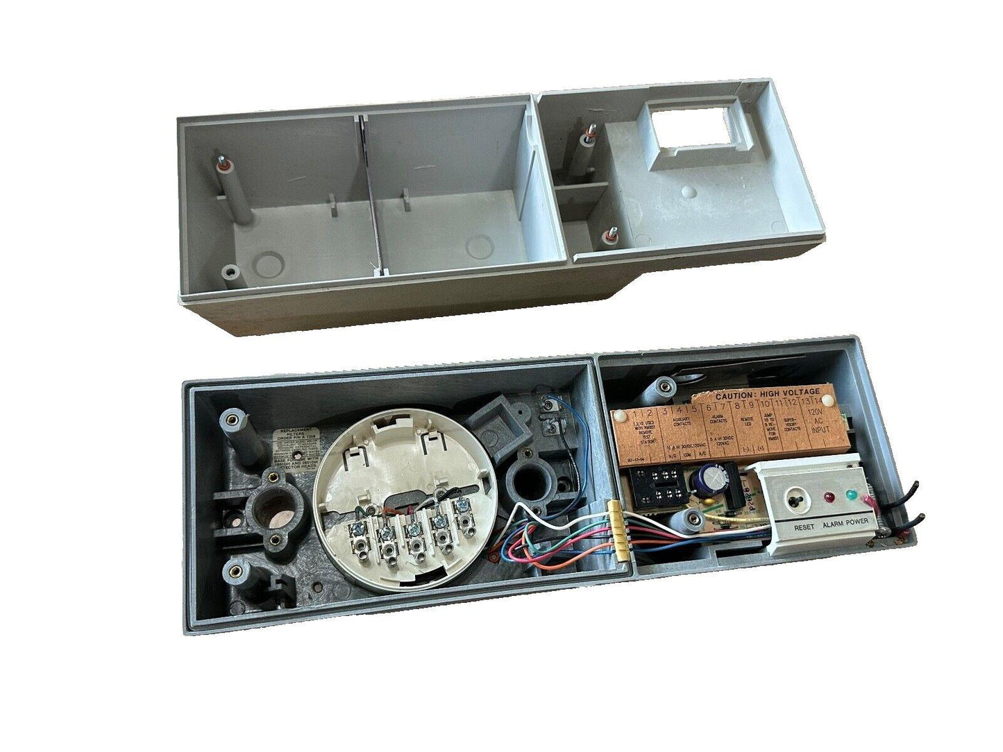 Fire alarm control panel with wiring terminals, reset button, and high voltage warning label for commercial use