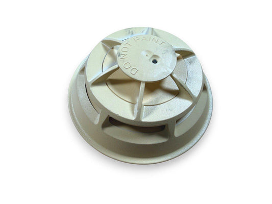 Beige fire alarm smoke detector with 'DO NOT PAINT' label, used fire safety equipment