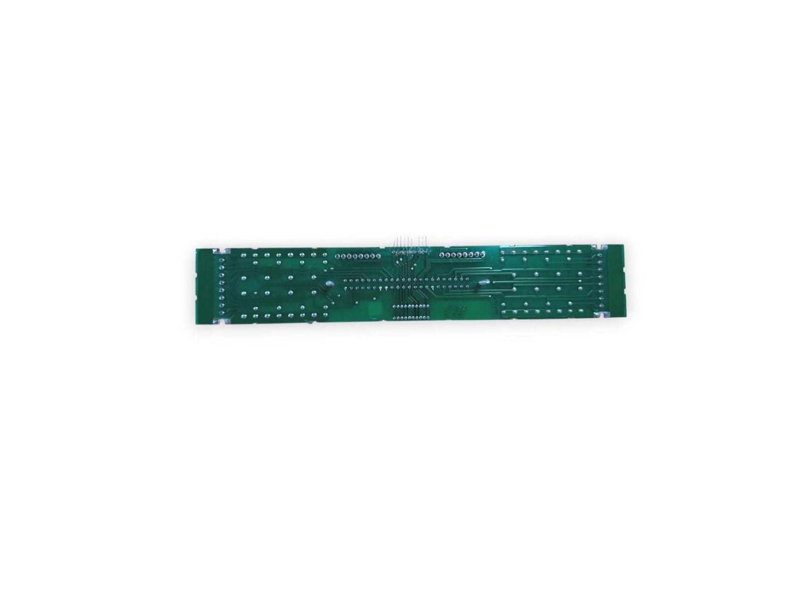 Green fire alarm control panel circuit board with solder points and traces, for fire safety systems