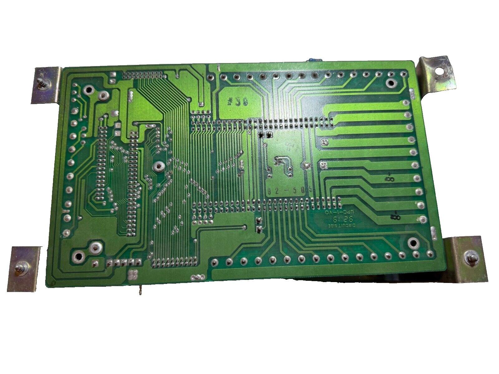 Green fire alarm control panel circuit board with mounting brackets, used fire alarm equipment