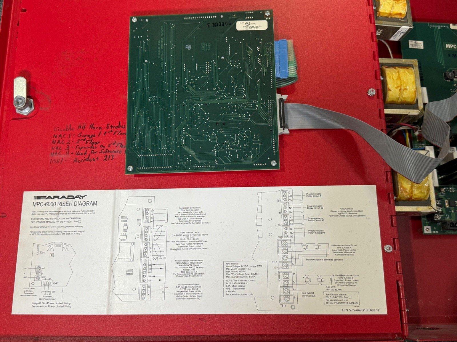 Faraday MPC-6000 fire alarm control panel circuit board with wiring diagram and red enclosure