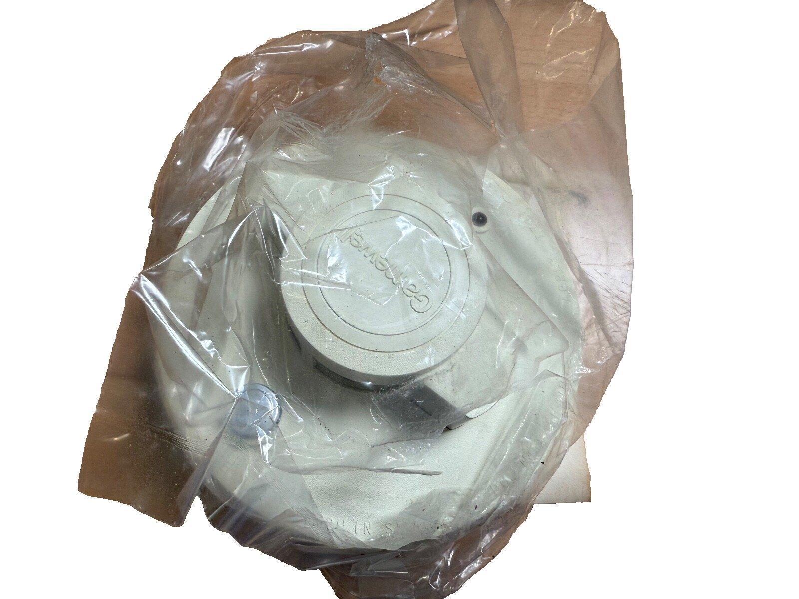 Gentex fire alarm smoke detector in plastic wrap, white circular unit for safety systems