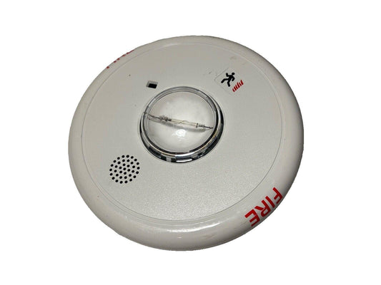 White fire alarm detector with red FIRE label and emergency exit symbol, used fire safety equipment