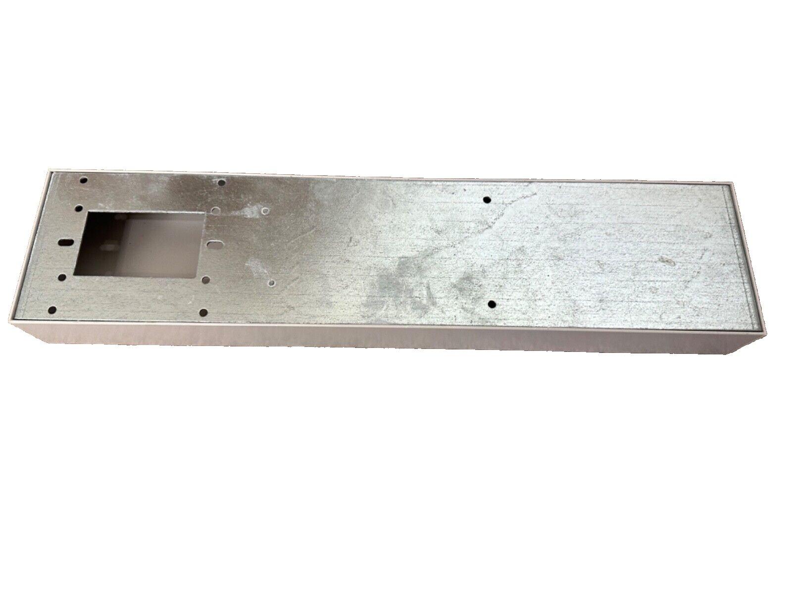 Metal fire alarm control panel enclosure with mounting holes and cutout