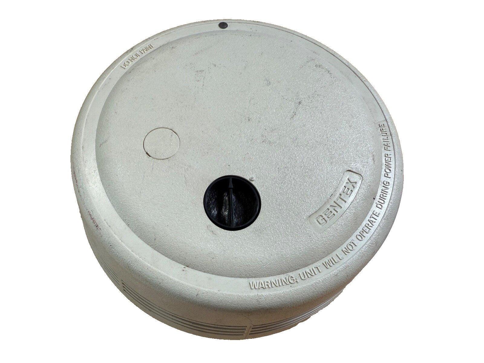 Gentex fire alarm detector with warning label, used fire safety equipment