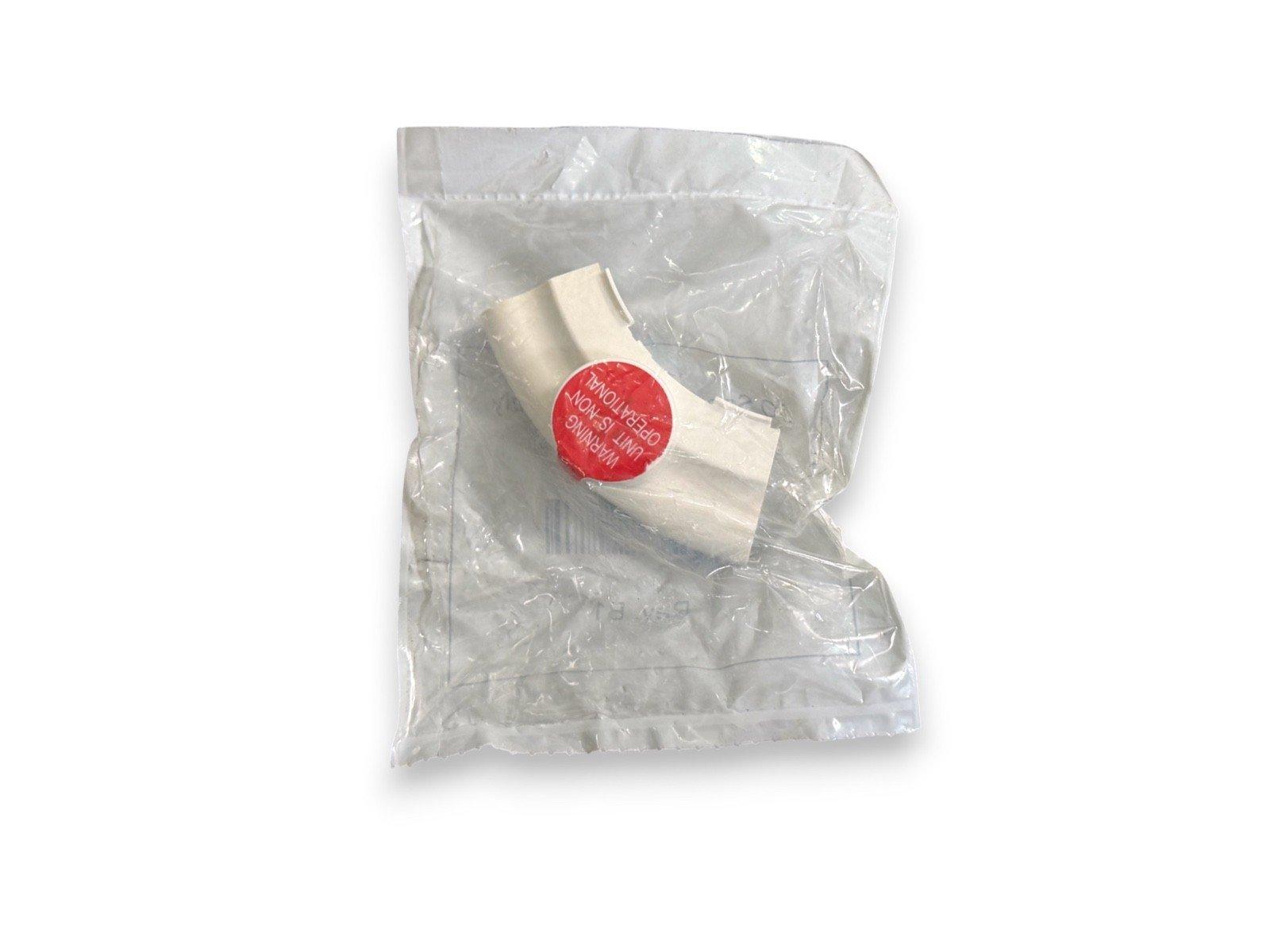 White fire alarm component in plastic bag with red warning label, non-operational unit
