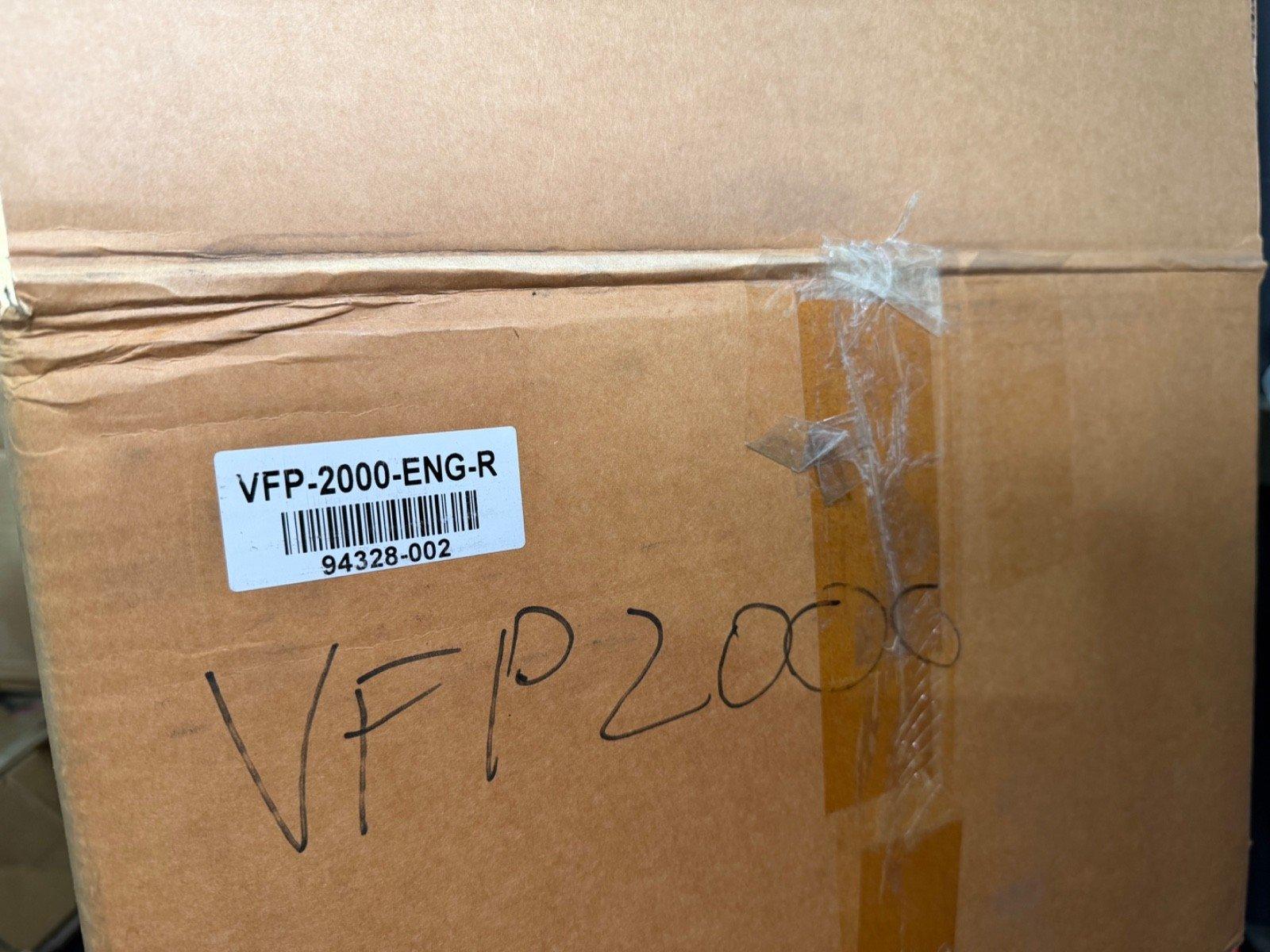 VFP-2000-ENG-R fire alarm equipment box with barcode and handwritten label, ready for shipping