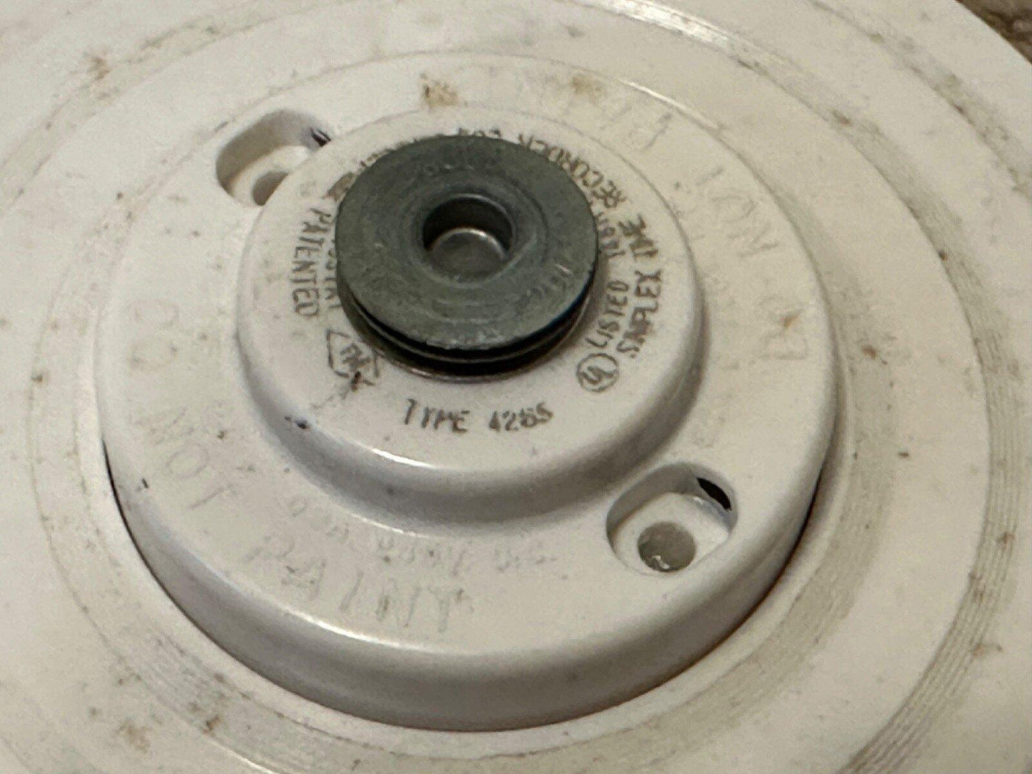 Simplex Type 4255 fire alarm device, white base with metal center, used fire safety equipment