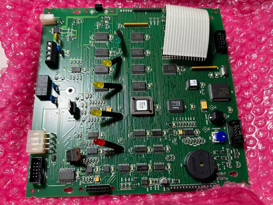 Fire alarm control panel circuit board with LEDs and connectors on pink bubble wrap