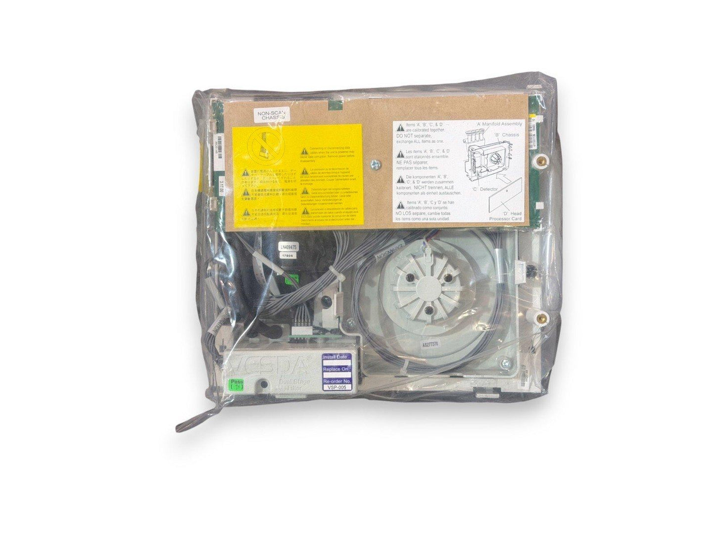 Sealed fire alarm control panel with wiring, labels, and warning stickers for safety compliance