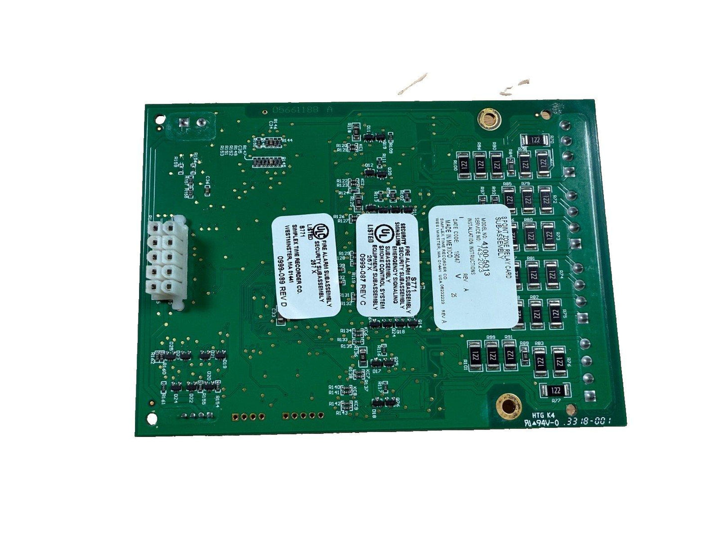 Green fire alarm control panel circuit board with UL listed security subassembly labels and relay components