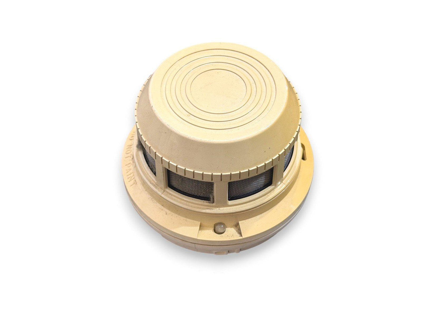 Beige smoke detector with mesh vents and circular design for fire alarm systems