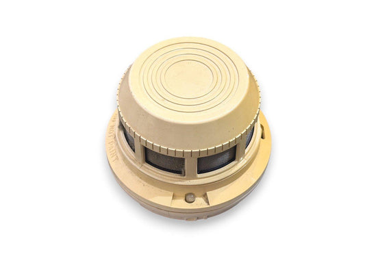 Beige smoke detector with mesh vents and circular design for fire alarm systems