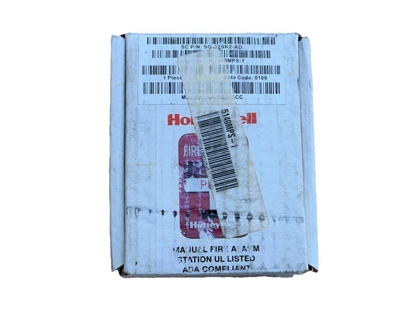 Honeywell manual fire alarm station box, UL listed, ADA compliant, with part number and barcode labels