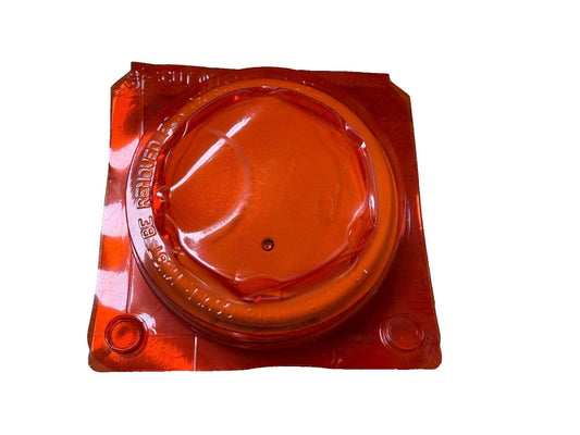 Red fire alarm strobe cover with clear plastic packaging for safety equipment