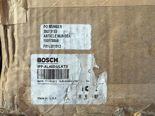 Bosch IPP-AL400-ULKT3 fire alarm power supply, made in USA, on shipping box with PO and article numbers