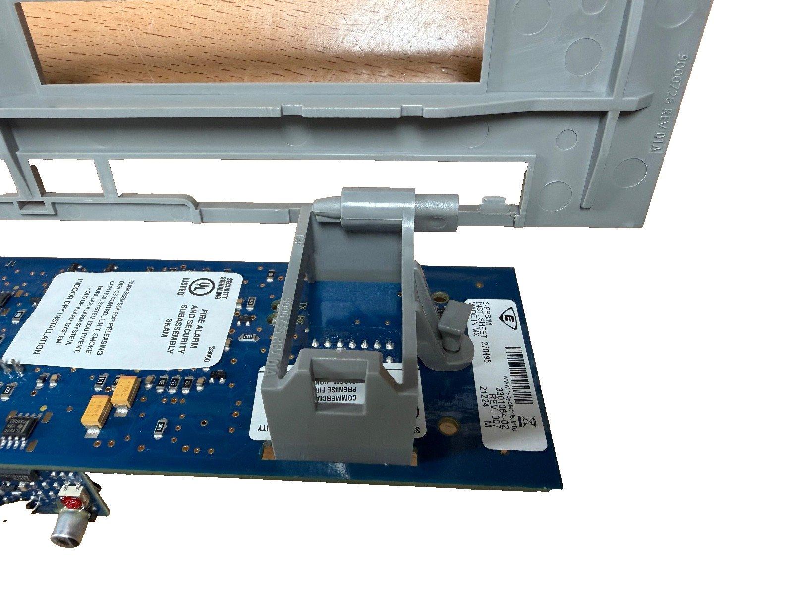 Fire alarm control panel circuit board with UL listed security subassembly and mounting bracket