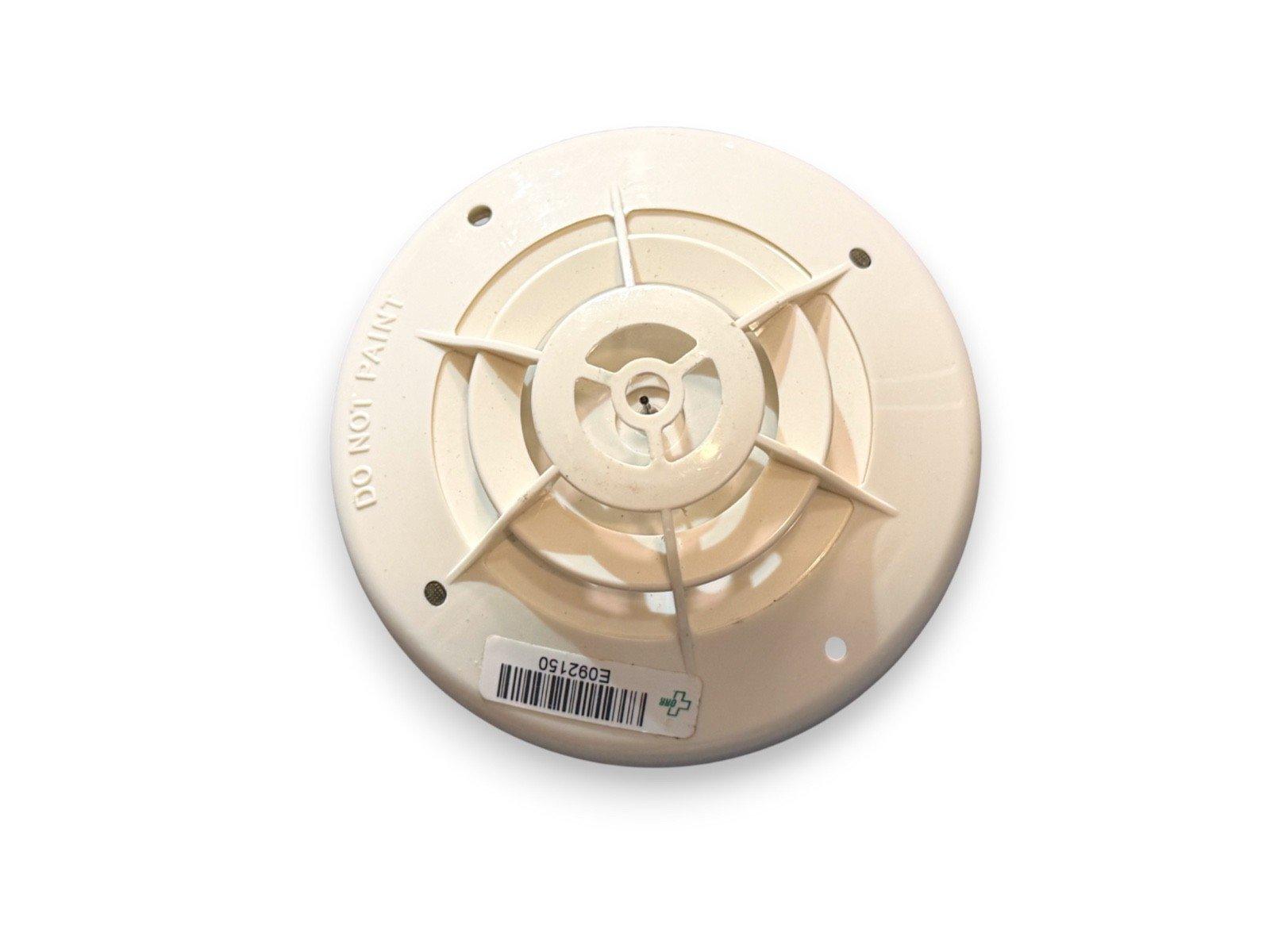White ceiling-mounted fire alarm detector with 'DO NOT PAINT' warning and barcode label