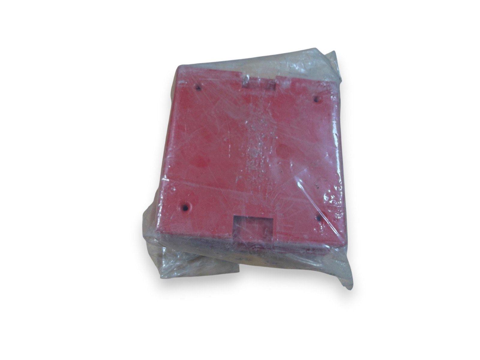 Red fire alarm pull station in plastic wrap, new surplus equipment for safety systems
